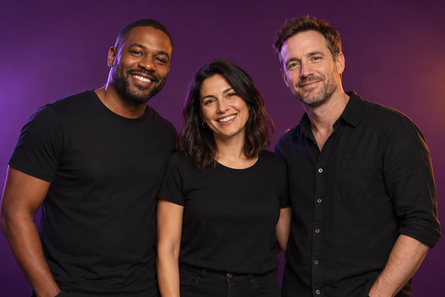 Three adults smiling together against a purple studio background
